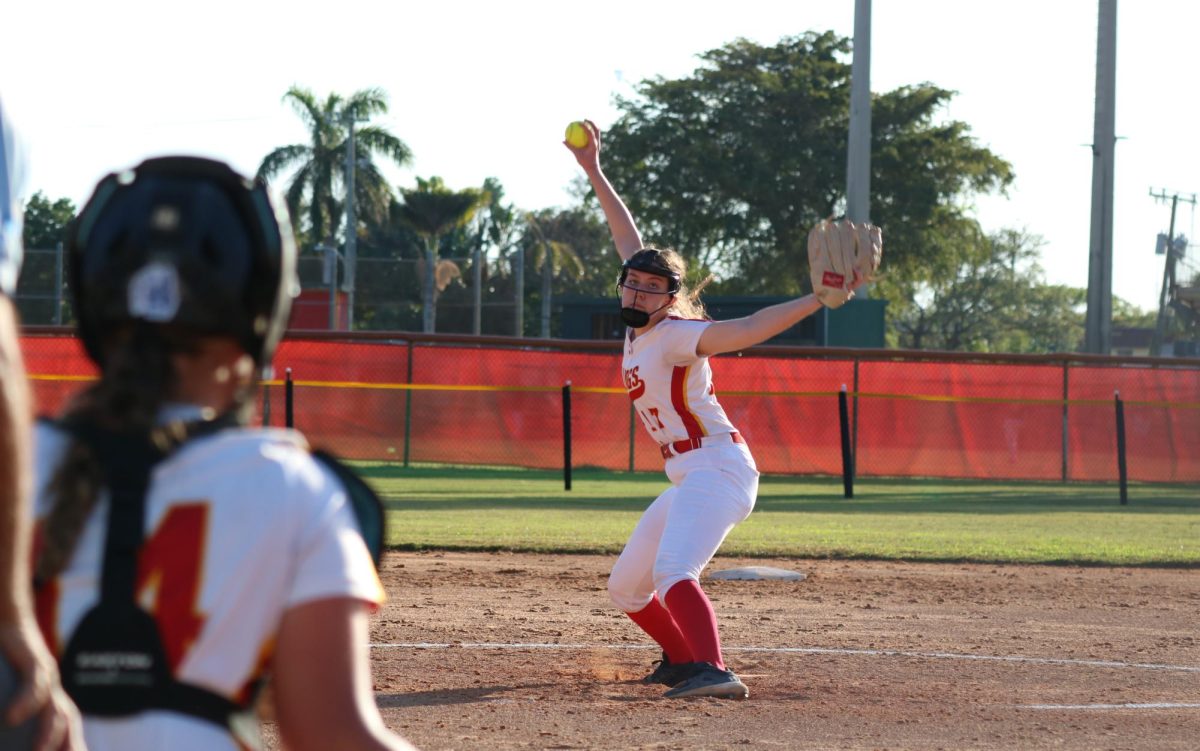 Senior Isabel Wellins unleashes her formidable pitching skills for South Broward, warming up with precision and power.