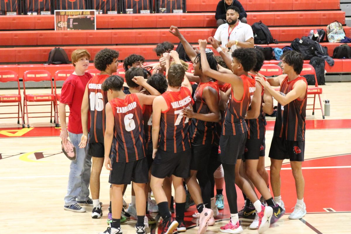 The Varsity Boys Volleyball team come together before game start to strategize a good game plan.