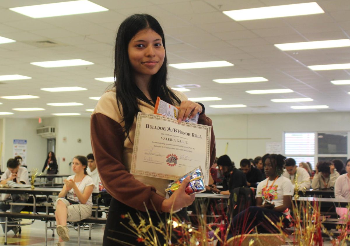 Valeria Galue shows off her grant at the Aand B honor roll celebration