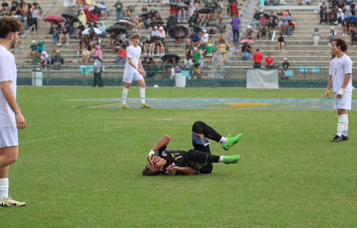 Angelo Rodriguez grimaces in agony as he clutches his head, following a harsh foul by one of Vieras midfielders. 