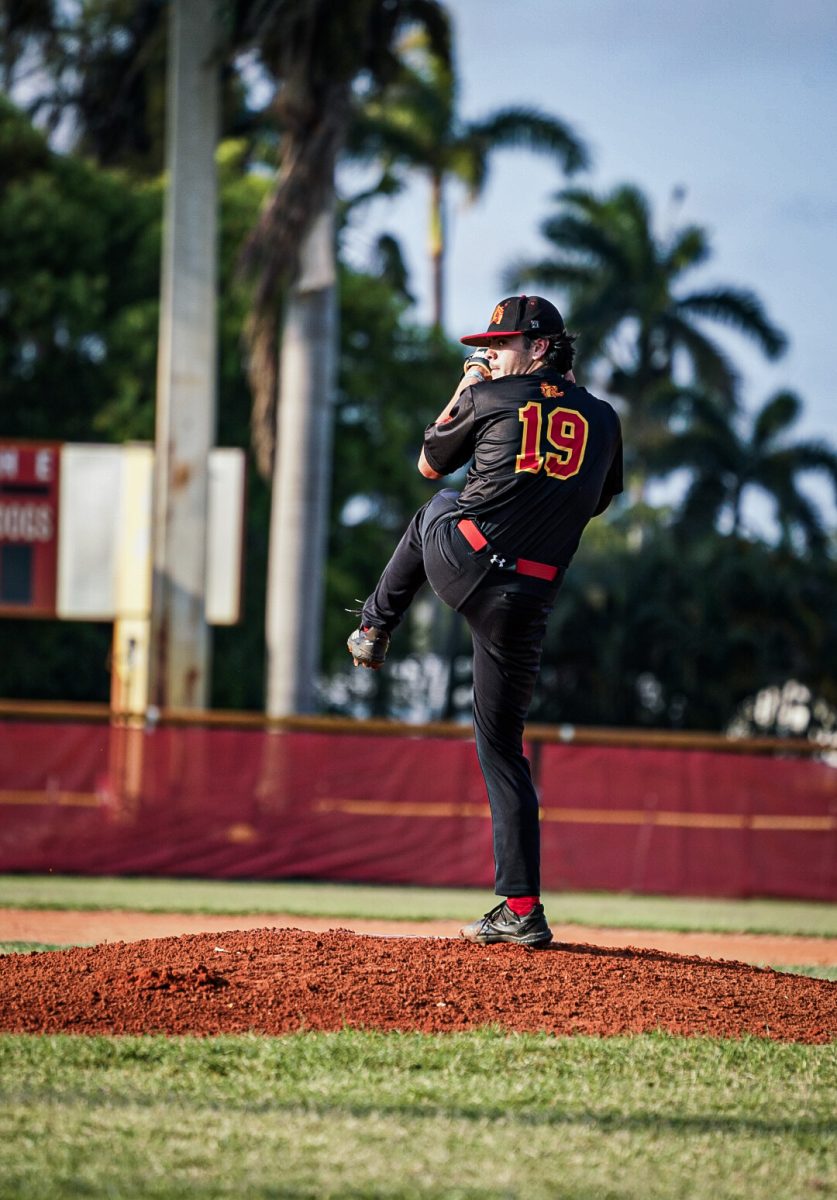 SBHS+senior+and+starting+pitcher+Johnny+Leuchauer+winds+up+to+fire+a+pitch+over+the+plate+during+the+first+round+of+regional+playoffs.+Leuchauer+held+off+the+Doral+Firebirds+for+four+innings.+The+Bulldogs+ultimately+beat+the+top+ranked+team+8-6+making+it+the+first+time+South+Broward+won+a+regional+playoff+game+in+14+years.