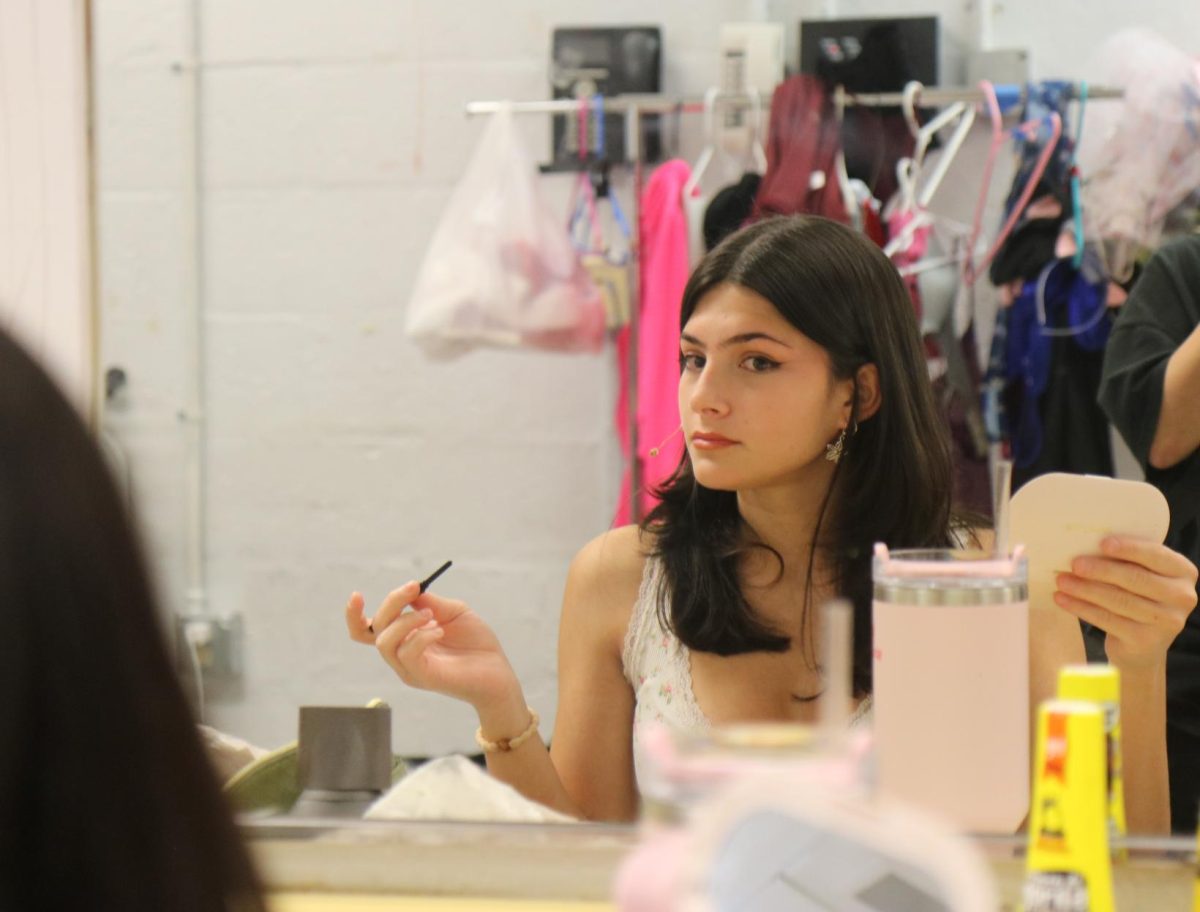 Emmy Grace gracefully does her make-up in preparation for her striking on stage performance as Karen Smith in the Mean Girls Musical.