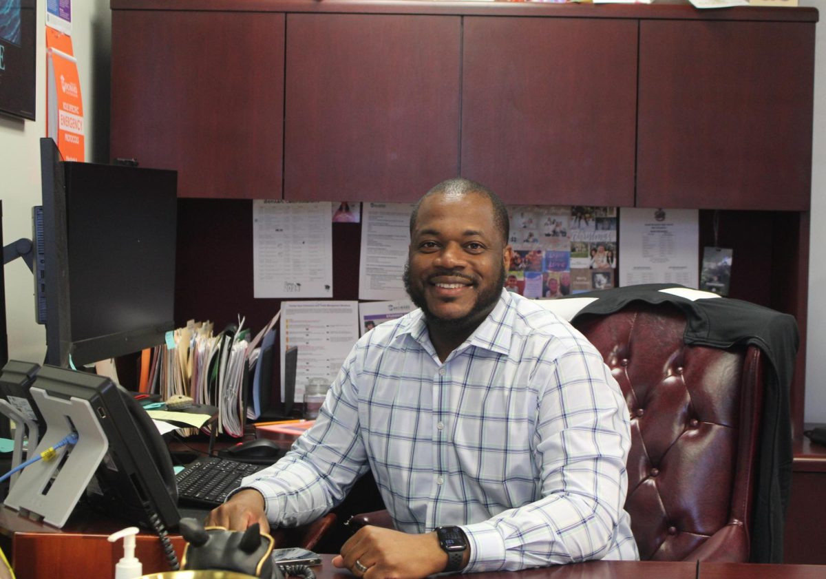 South Broward High School Principal Alexander Francois sits at his desk in his office. This year, he took over the position of principal of Mrs. Patricia Brown, who left to become the Director of Athletics & Student Activities for Broward County Public Schools.