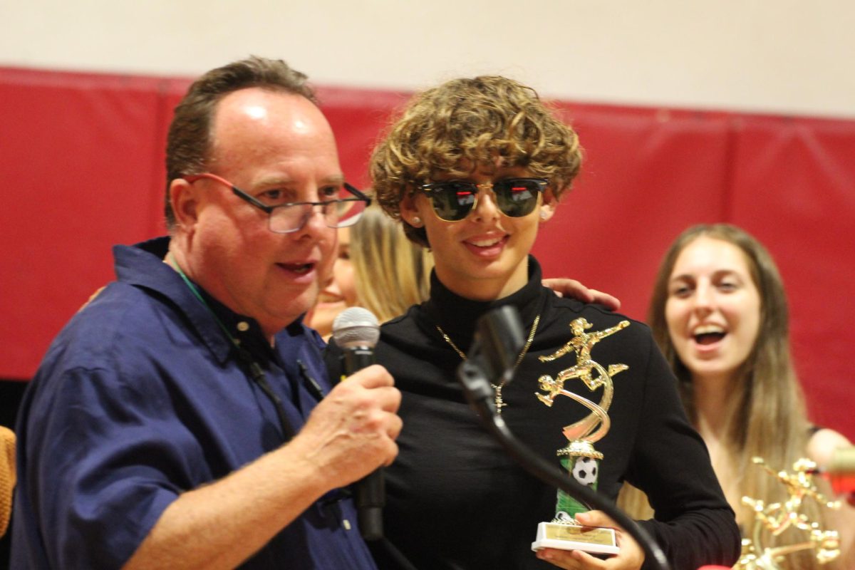 Coach Boomer congratulates Maria Capellan with a small speech and a soccer award.