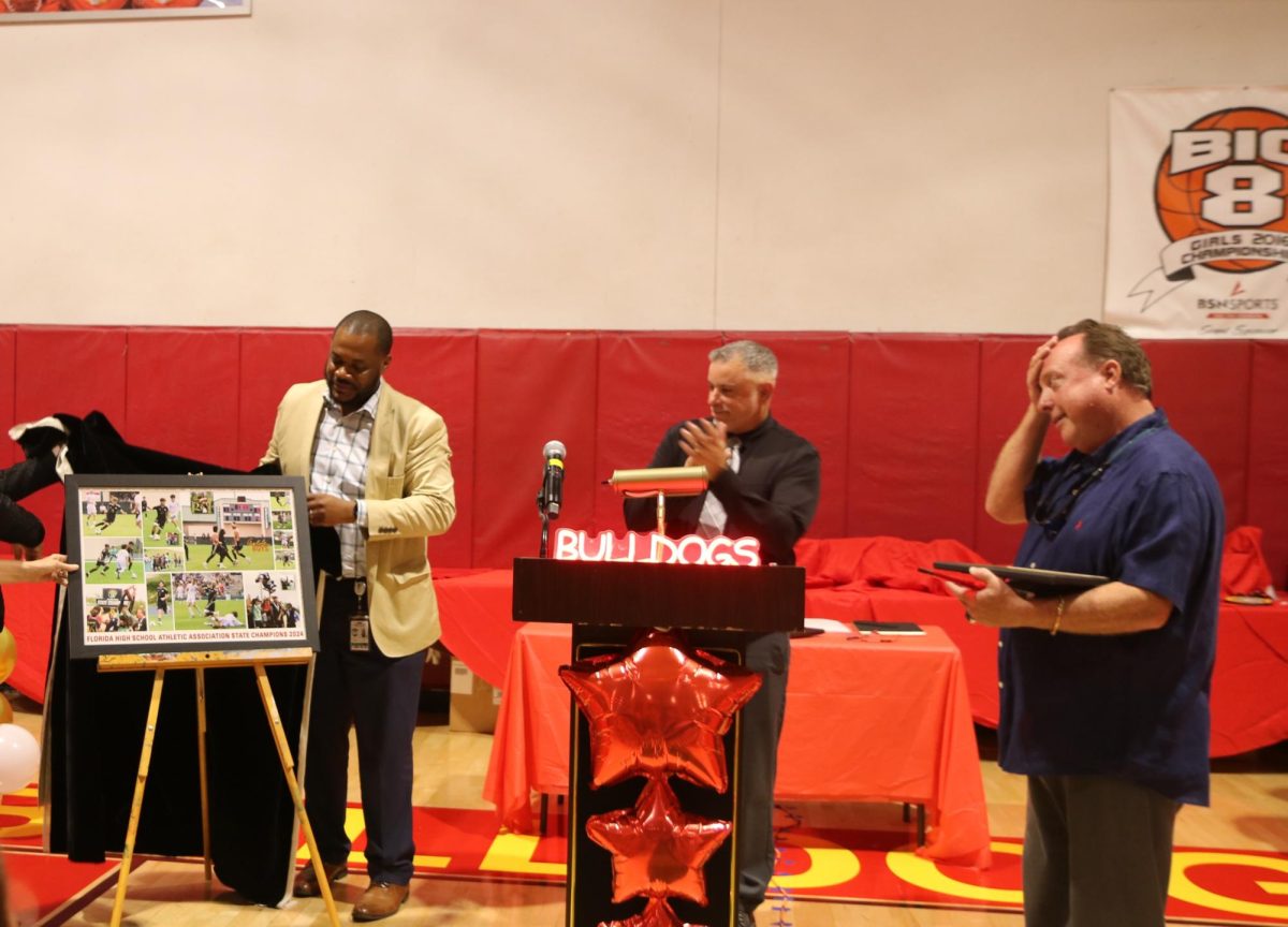 During Coach Boomer and Mr. Windburn's speech, Mr. Francois unravel the soccer team's big accomplishment of wining the championships.