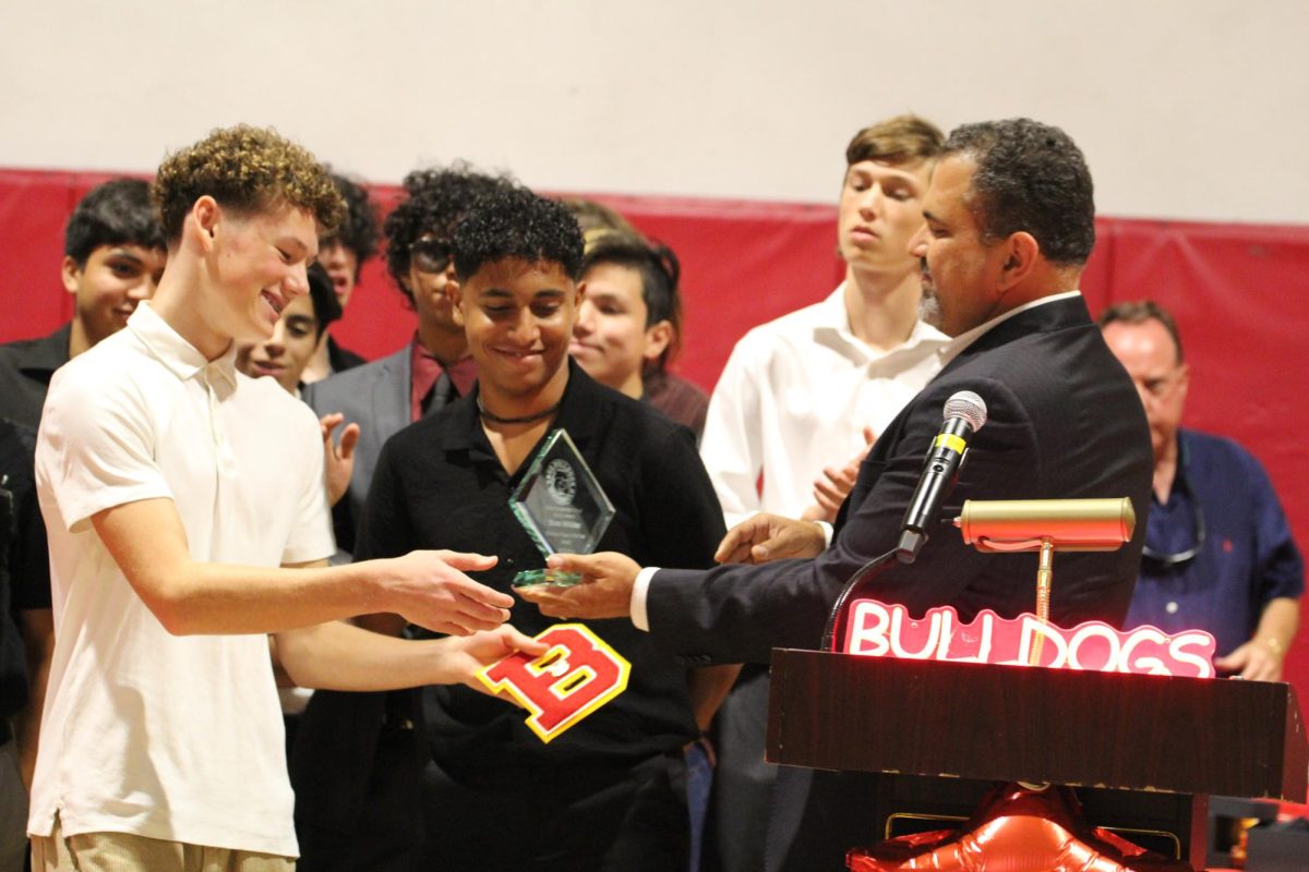 Shane Witicker receives his player of the year award with a great smile from Coach Tal Mazor.