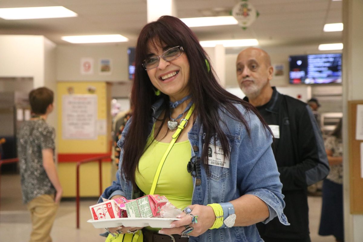 As the grandparents go through the lunch line to gather their breakfast provided by the SBHS staff one of the grandmothers Mrs. Laboy decide to pose for a photo.