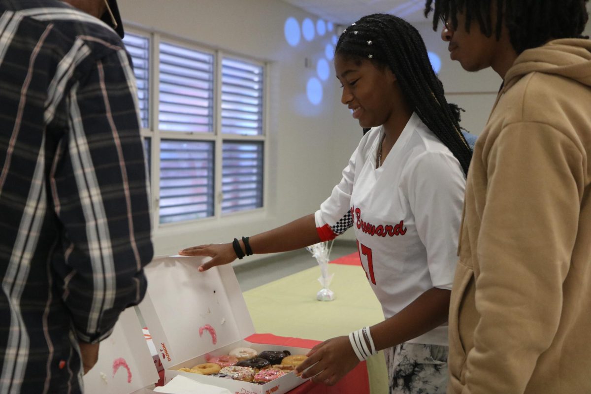 Onya Golightly, goes to grab a delicious delight of donuts with her family at the grandparents event.