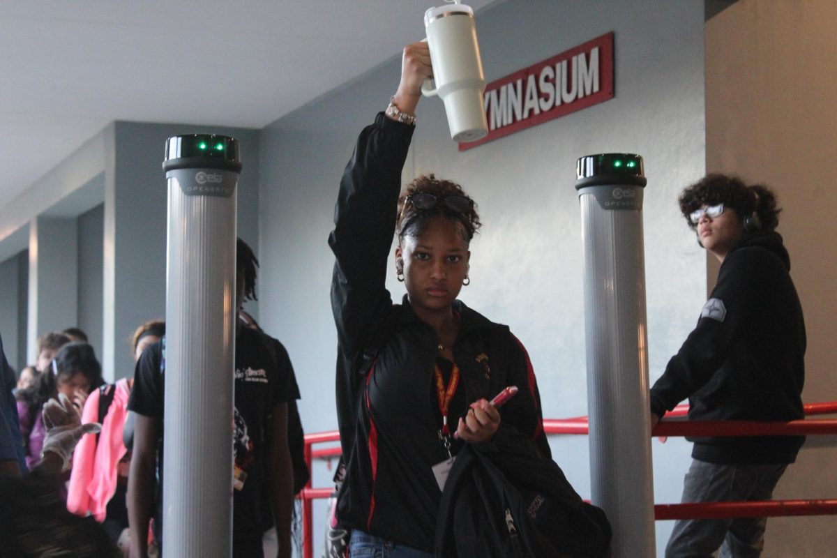 Sophomore Syria Gonzalez-Colman uses the new technique, holding up her Stanley cup, that the staff of SBHS came up with to make the line go much more efficient.