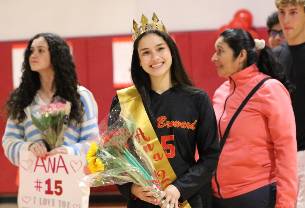 Senior Ana Vegas strikes a confident pose for the camera, holding thoughtful gifts from her teammates.