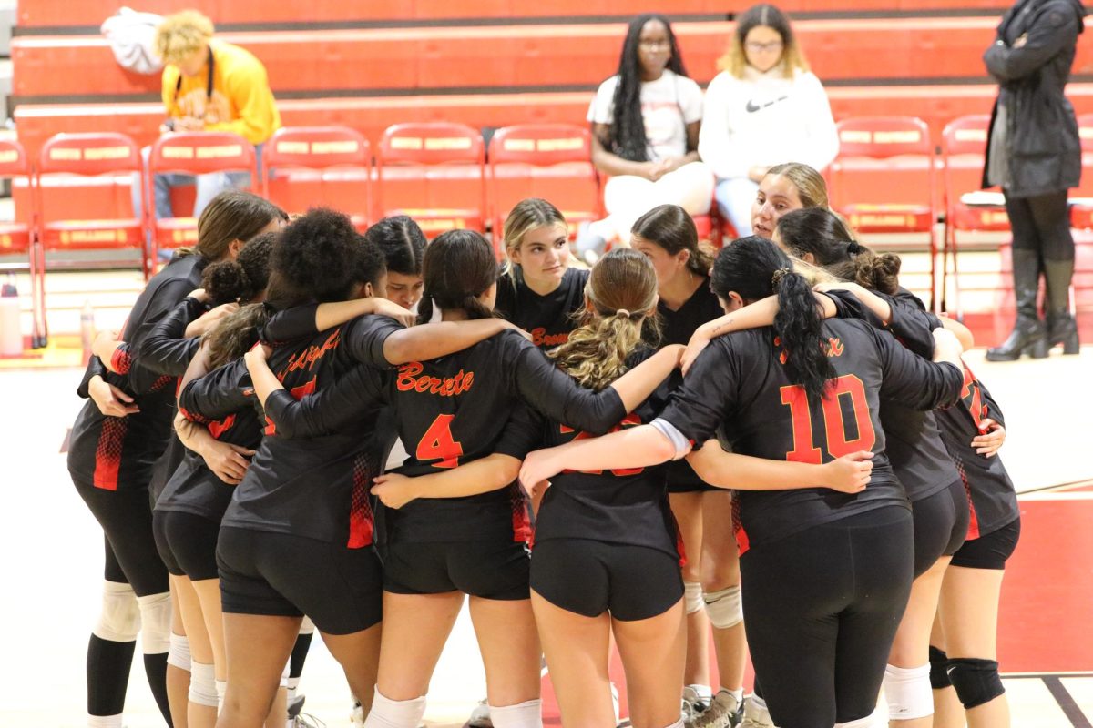 The SBHS Lady Bulldogs erupt in celebration after securing a hard-fought victory in a challenging set, their teamwork and perseverance shining through in every point.