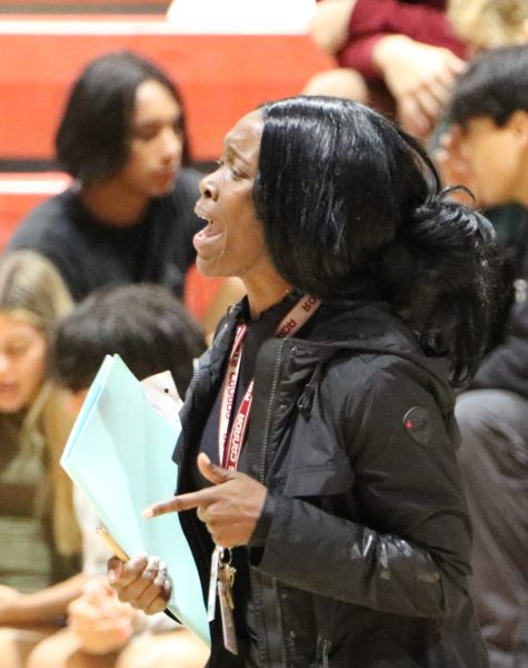 Coach Rolle demonstrates her passion and commitment, rallying the team with energetic shouts.