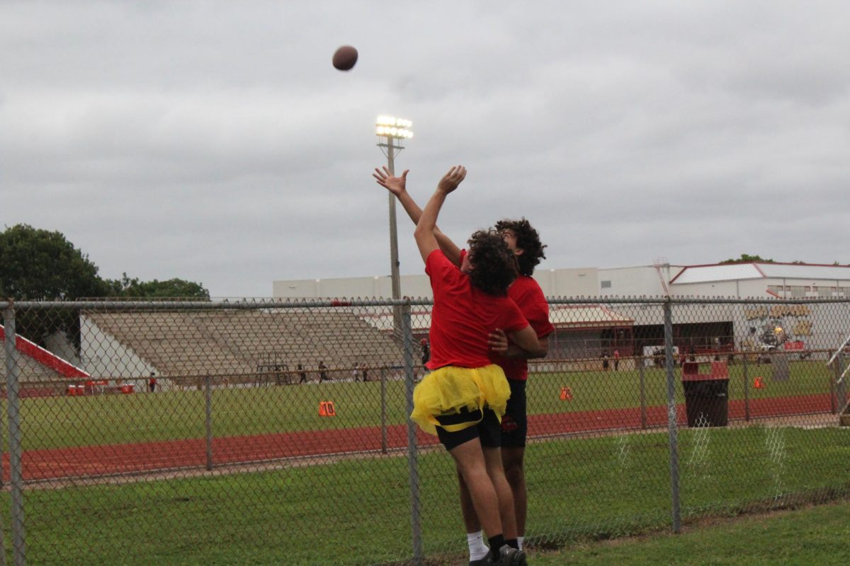 SBHS senior students Lucas ---- and Misha ---- jump at the same time to catch the football.