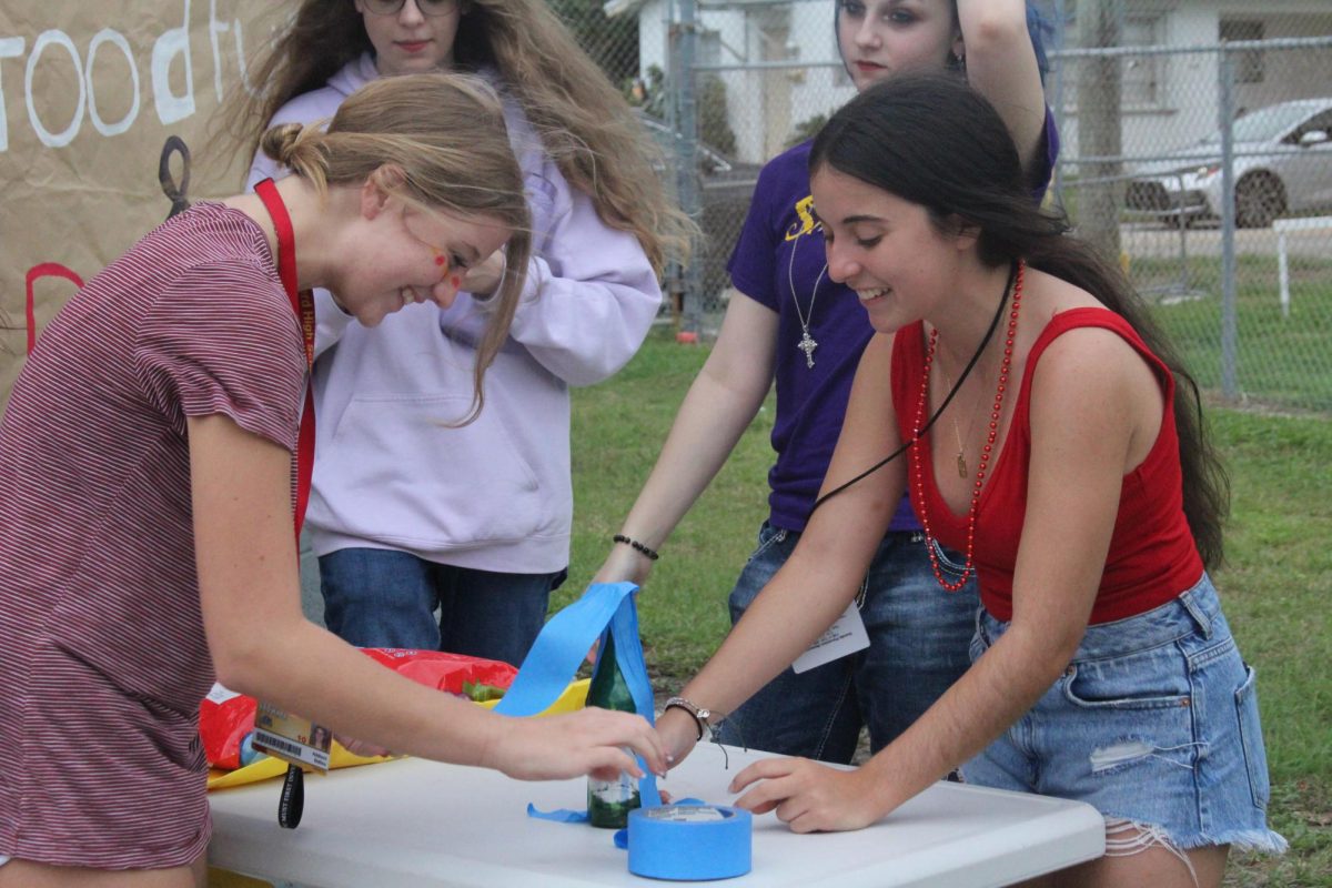 Isabella and ____ setting up games for students to have fun at tailgate. 