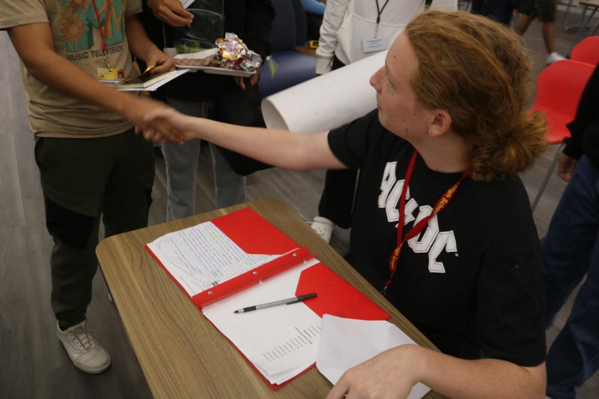 SBHS Junior Ben Soren, the Spelling Bee's coordinator shaking Martin Segui’s hand. 
