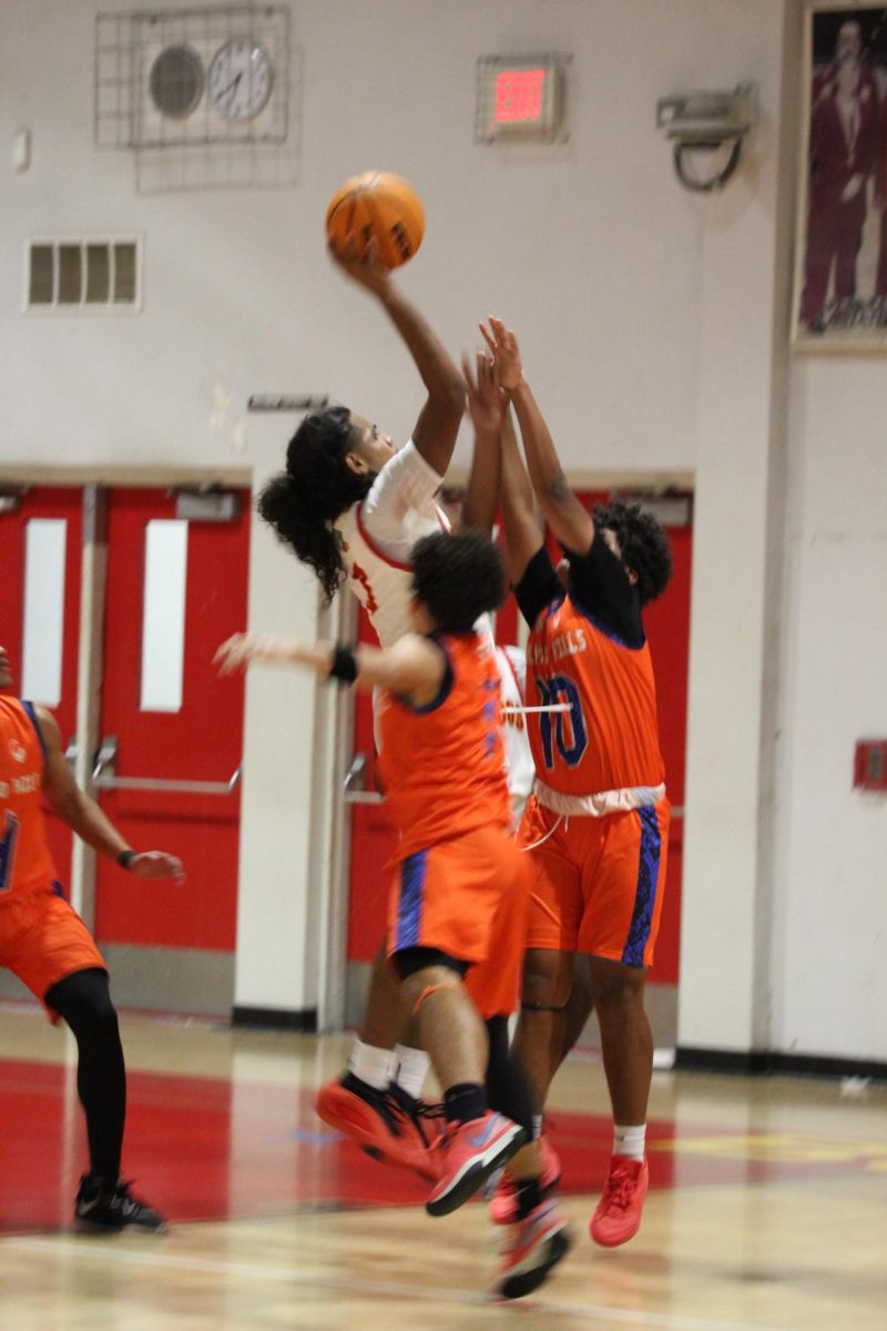 SBHS Varsity Junior, Nelson Maldonado succeeds an impressive steal against two Hollywood Hill opponents.