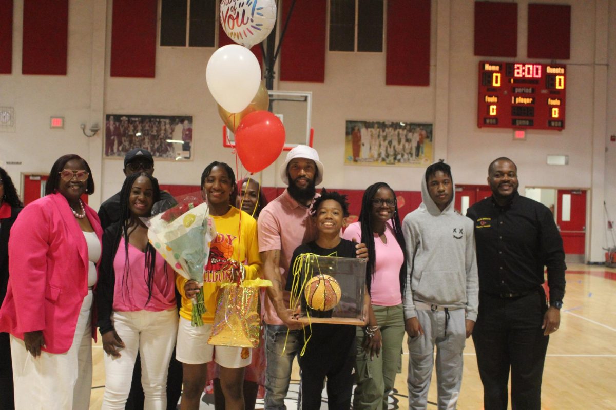 SBHS senior Aniyah Cowart receives her reward at the Senior Night Ceremony with her family.