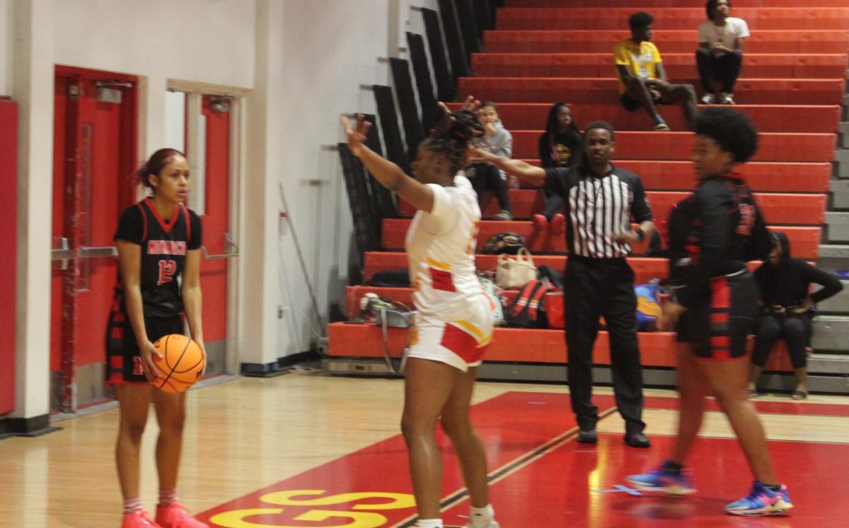 Ayonna Lewis guarding her opponent from Monarch.