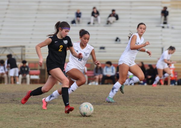 SBHS freshman Sandra Sica sprints down the field, skillfully creating a goal-scoring opportunity for her team, while Somerset's Sophia Valdez races to block her path.