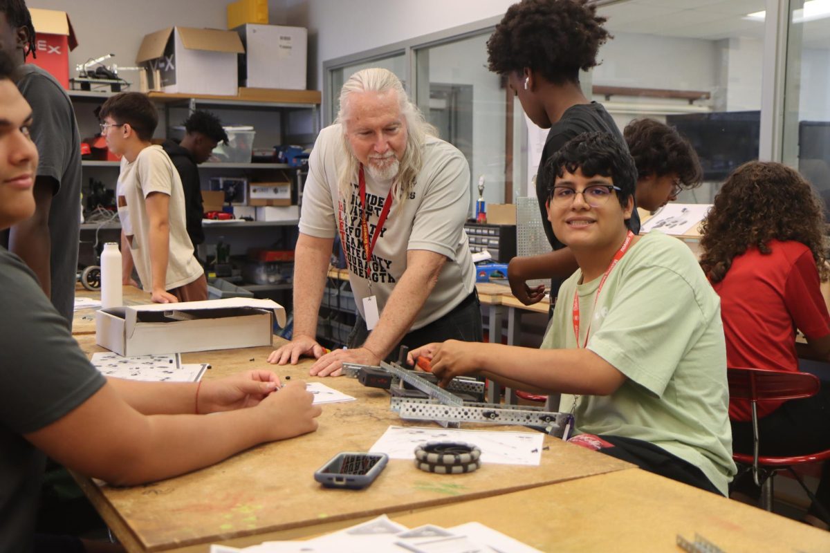 SBHS teacher Mr Hagerty helps his student assemble his machine.