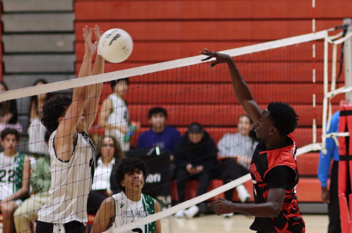 South Broward senior Rubin Obas leaps high for a powerful spike, delivering a critical point in the intense third set.