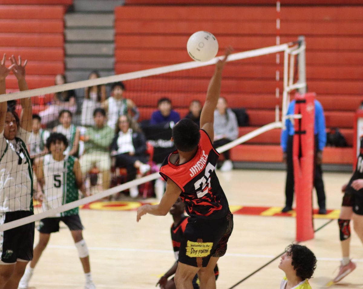 Outside hitter Elijah Jimenez rises for the kill, delivering a fierce and foreboding spike.