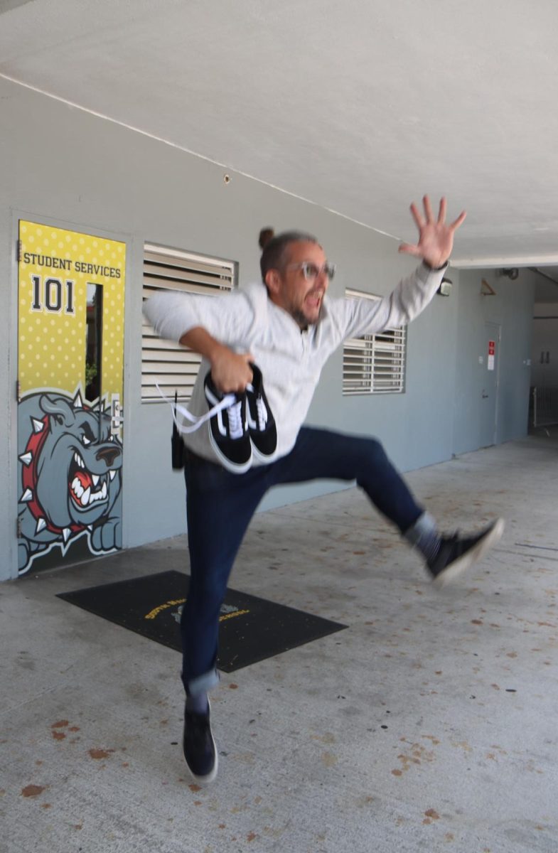 Mr. Nathan Eldred-Banks leaps for joy after scoring a pair of brand new Vans he found at the school thrift store.