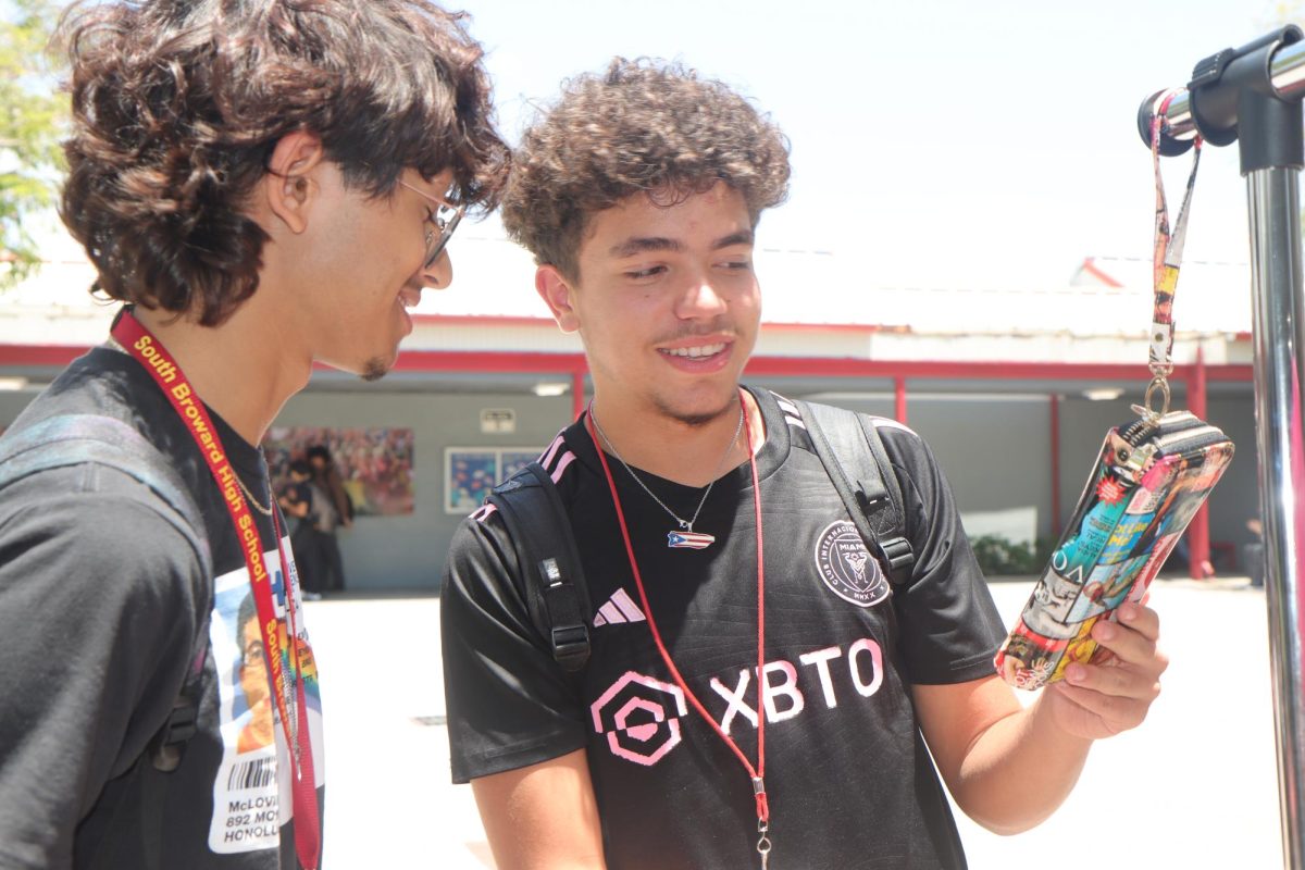 Guillermo Mejia-Reis, 11, and Trace Victoria, 9, check out a unique wallet as they discus the vivid designs that are exhibited on the wallet.