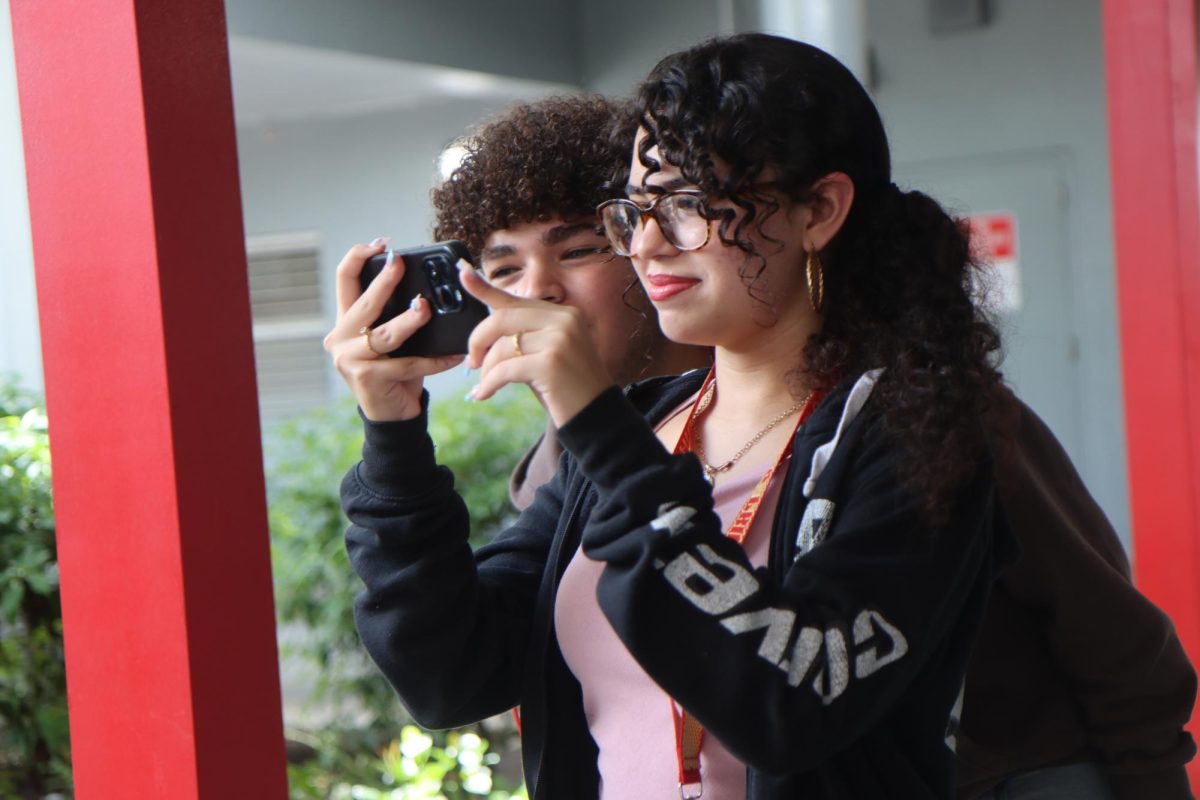 Sophomores Diego Rodriguez and Daniela Rodriguez go around the 101 courtyard, documenting student-led activities throughout the event.