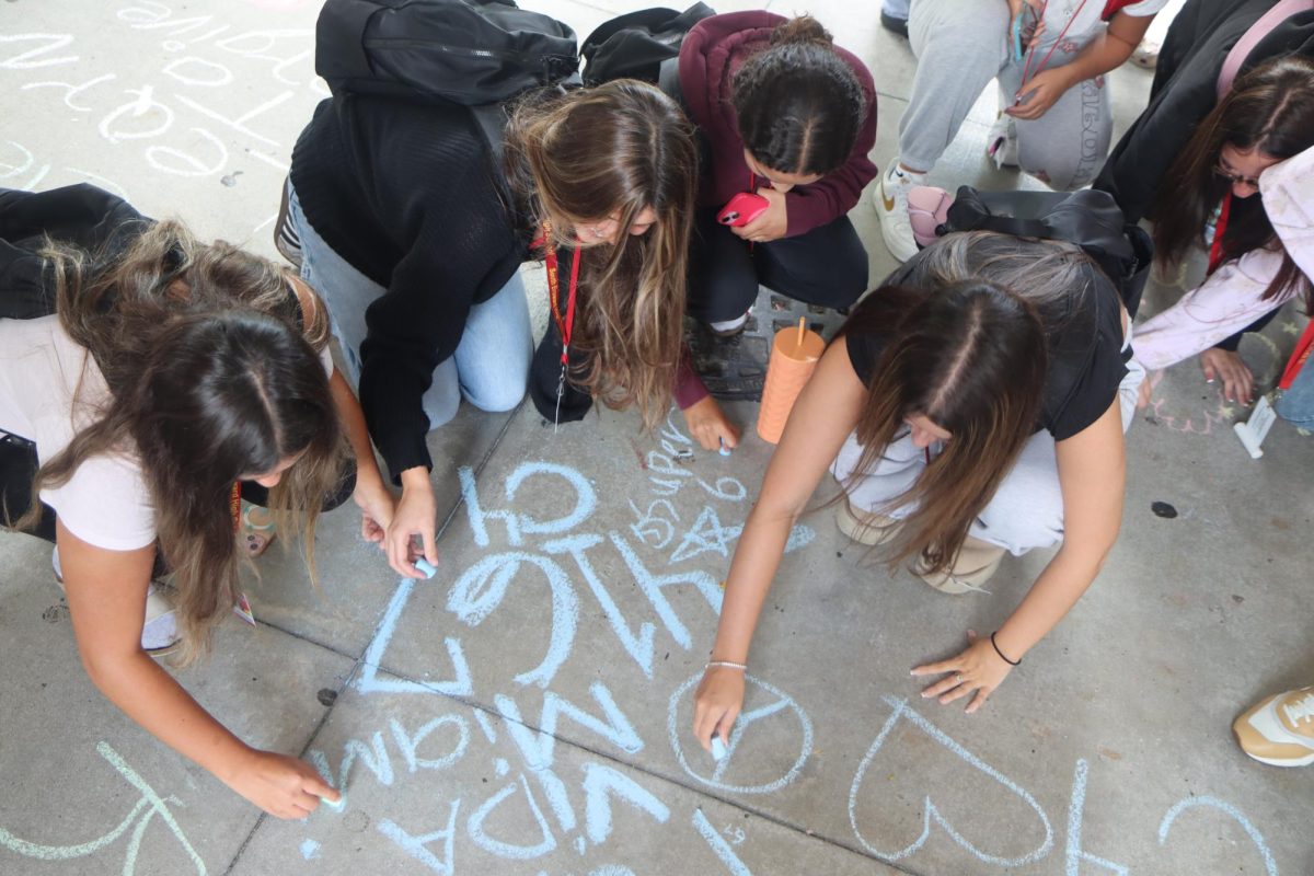 Juniors Audrina Ramos, Sofia Alonso, and Sofia Lopez Candioti, along with Sophomore Ella Sarch, use chalk to create powerful messages on the pavement, lending their voices to the movement to end gun violence.