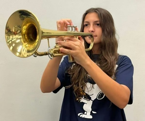 Erika Alvarez sharpens her trumpet skills, focused on hitting every note just right.