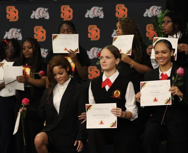 Mentoring Tomorrow’s Leaders and 5000 Role Models students proudly hold their certificates of induction following a successful ceremony on December 2, 2026. The event recognized their dedication, training, and readiness to serve as official members of the South Broward High School MTL chapter.