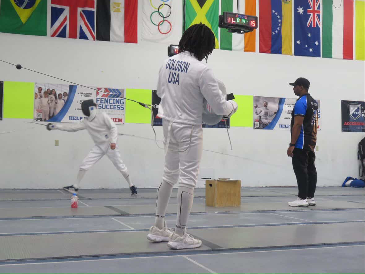 Tyrese Goldson readies his equipment before a pending fencing match.