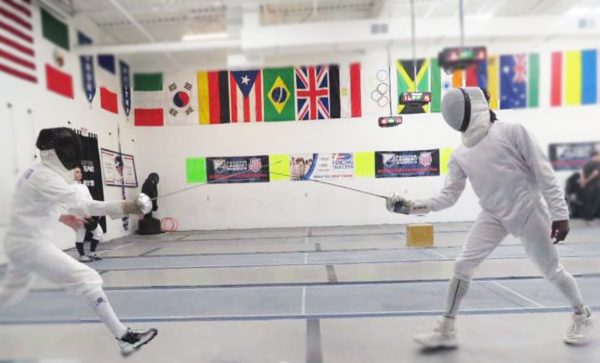 Tyrese Goldson, right, fends off an attack by an opponent in a fencing competition. Goldson recently placed 10th in the nation for Épeé-style fencing.